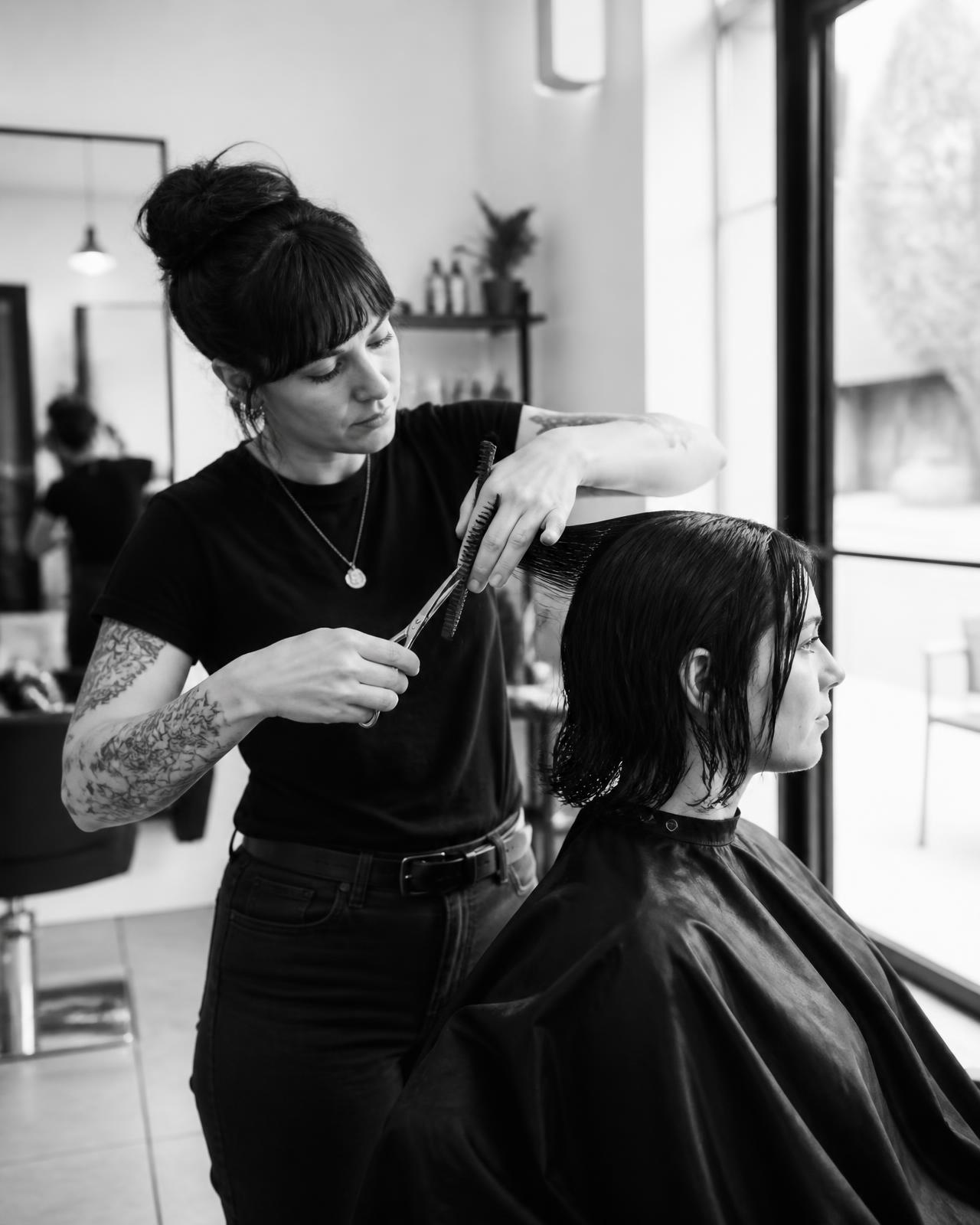 Sur Mesure Salon stylist cutting a client's hair